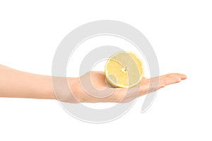 Healthy eating and diet Topic: Human hand holding half of lemon isolated on a white background in the studio