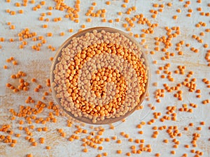 Healthy eating and dietary. Bowl of raw red lentil on white wooden background. Top view. Flat lay. Masoor Dal or