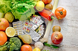 Healthy eating - healthy food, eating organic fruit and vegetable and nutrition supplement photo