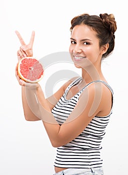 Healthy eating and freshness. Joyful young woman with citrus fruit