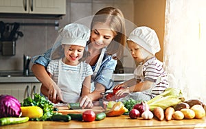 Healthy eating. Happy family mother and children prepares veget