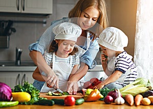 Healthy eating. Happy family mother and children prepares veget