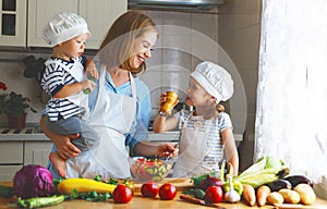 Healthy eating. Happy family mother and children prepares vegetable salad