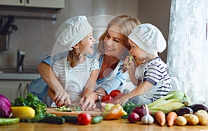 Healthy eating. Happy family mother and children prepares vegetable salad