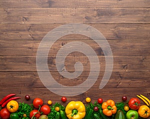 Healthy eating ingredients: fresh vegetables, fruits and superfood. Wooden background