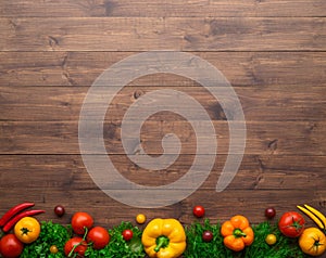 Healthy eating ingredients: fresh vegetables, fruits and superfood. Wooden background