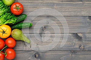 Healthy eating ingredients: fresh vegetables, fruits and superfood. Wooden background