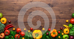 Healthy eating ingredients: fresh vegetables, fruits and superfood. Wooden background