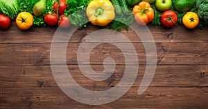 Healthy eating ingredients: fresh vegetables, fruits and superfood. Wooden background