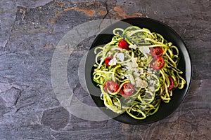 Healthy eating, low carb diet zucchini pasta. Top view on a dark slate background.