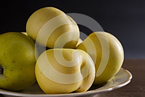 healthy eating. many green apples in a plate on a dark background