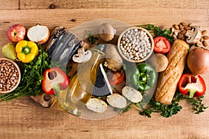 Healthy eating. Mediterranean diet. Fruit,vegetables, grain, nuts olive oil and fish on wood