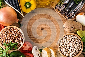 Healthy eating. Mediterranean diet. Fruit,vegetables, grain, nuts olive oil and fish on wood
