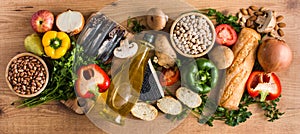 Healthy eating. Mediterranean diet. Fruit,vegetables, grain, nuts olive oil and fish on wood