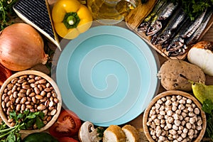 Healthy eating. Mediterranean diet. Fruit,vegetables, grain, nuts olive oil and fish on wooden table. Top view photo