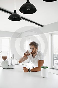 Healthy Eating. Muscular Man Drinking Sports Shake Drink Indoors