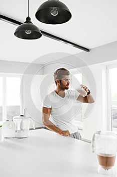 Healthy Eating. Muscular Man Drinking Sports Shake Drink Indoors