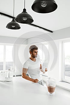 Healthy Eating. Muscular Man Drinking Sports Shake Drink Indoors