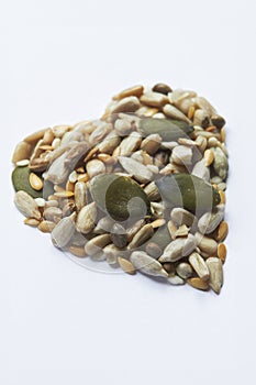 Healthy Eating Shot With Nuts And Seeds In Shape Of A Heart On White Background
