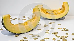 Healthy Eating. Two slices of fresh ripe pumpkin pumpkin with seeds isolated on white background.