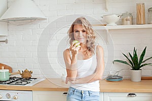 Healthy eating, vegetarian food, dieting concept. Young woman with green apple