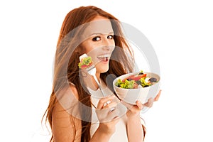 Healthy eating - woman eats a bowl of greek salad isolated over