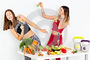 Healthy Eating Women Cooking Salad. Beautiful Smiling Vegan Girls Going To Eat Fresh Green Organic Vegetables. 