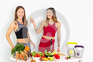 Healthy Eating Women Cooking Salad. Beautiful Smiling Vegan Girls Going To Eat Fresh Green Organic Vegetables In Kitchen. Happy Pe