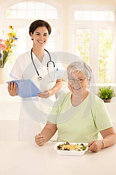 Healthy elderly woman eating salad