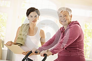 Healthy elderly woman on exercise bike