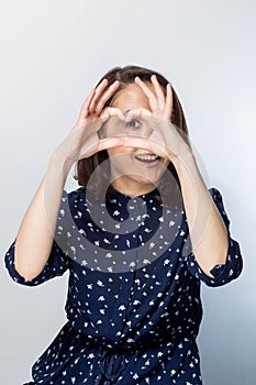 Healthy Eyes And Vision. Portrait Of Beautiful Happy Woman Holding Heart Shaped Hands Near Eyes.