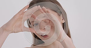 Healthy eyes and vision. Woman showing heart shape