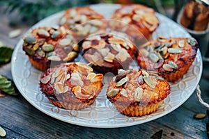 Healthy fall vegetarian dessert. Apple cupcake with pumpkin, almond seeds