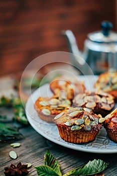 Healthy fall vegetarian dessert. Apple cupcake with pumpkin, almond seeds