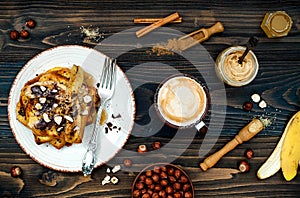 Healthy fall and winter breakfast. Vegan vanilla french toast with caramelized bananas, raw dark chocolate and hazelnut butter