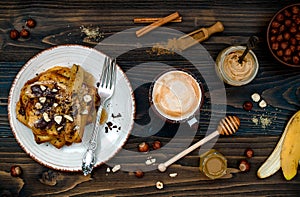 Healthy fall and winter breakfast. Vegan vanilla french toast with caramelized bananas, raw dark chocolate and hazelnut butter