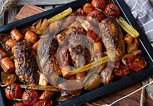 Healthy family meal with oven roasted chicken breast and vegetables on a baking tray