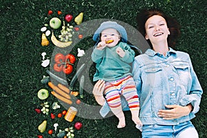 Healthy family nutrition. Mother and baby with fruits and vegetables.