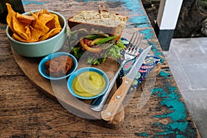 Healthy Fast food. burger with a chop, lettuce with sweet potatoes fries and two sauces. Tasty sandwich for lunch on