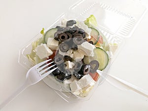 Healthy fast food salad in plastic box