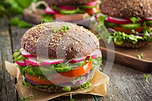 Healthy fast food. Vegan rye burger with fresh vegetables