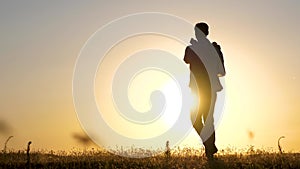 Healthy father and little daughter are spinning in a dance at sunset. free happy family. child plays with his father at