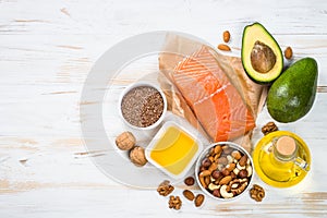 Healthy fats products at black background.