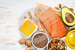 Healthy fats products at black background.