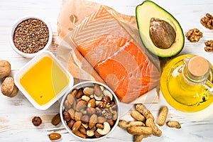 Healthy fats products at black background.