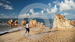 Healthy female running along beach in morning