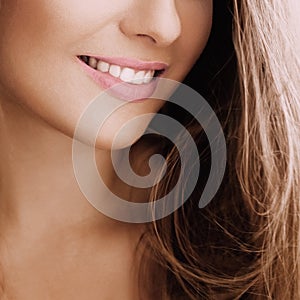 Healthy female smile with perfect natural white teeth, beauty face closeup of smiling young woman, bright lipstick