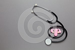 Healthy female uterus on grey background. Gynecological diseases and pain treatment. Reproductive system and pregnancy. Copy space