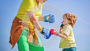 Healthy fighter Grandfather and grandson with boxing gloves. Little boy sportsman at boxing training with coach. Sports