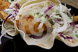Healthy Fish Taco with lettuces and sauce